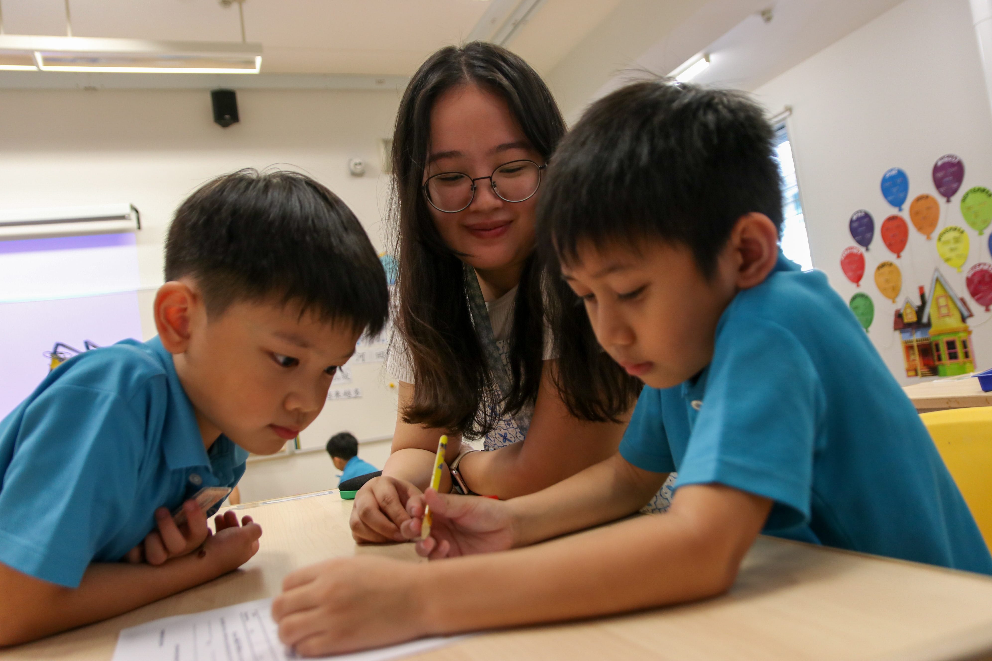 MOE Kindergarten children and teachers participate in a parachute activity during Level Day, fostering friendships, cooperation and a sense of belonging through shared play.